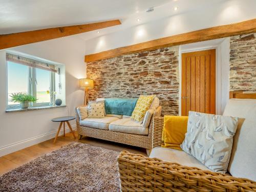 a living room with a couch and a chair at Horseshoe Cottage - Uk48252 in Downderry