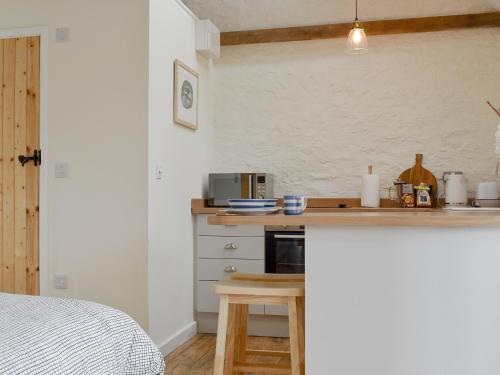 a kitchen with a counter top with a microwave at The Chaff House in Wookey