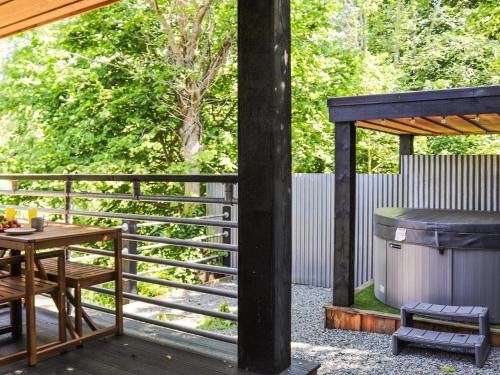 a patio with a table and a gas grill at Dinas Lodge - Uk47607 in Caernarfon
