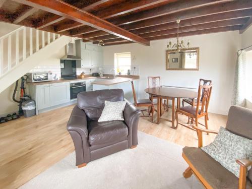 a kitchen and dining room with a table and chairs at Primrose Villa in Rosedale Abbey