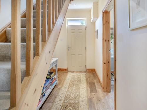 a staircase in a house with a wooden stair case at Farrington House in Lowthorpe