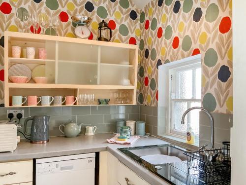 a kitchen with a sink and a window at Gable End Cottage in Goathland