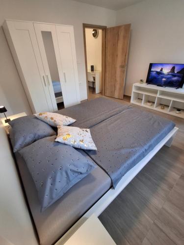 a large bed with two pillows in a room at Villa Ivana in Koper
