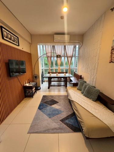 a living room with a couch and a table at Pico de Loro - Welki's Place in Nasugbu