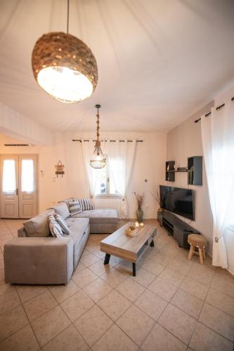 a living room with a couch and a table at Blue Horizon in Skopelos Town