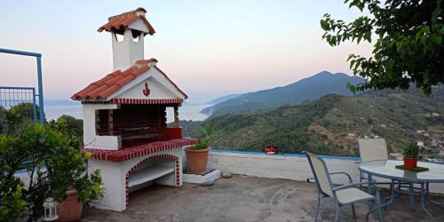 a table and chairs on a balcony with a view at Blue Horizon in Skopelos Town
