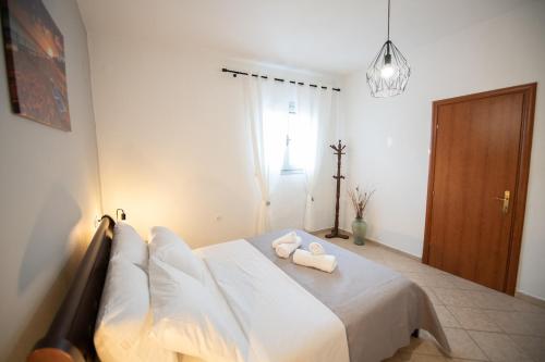 a bedroom with a bed with two pillows on it at Blue Horizon in Skopelos Town