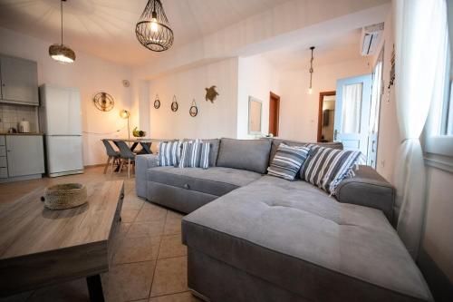 a living room with a couch and a table at Blue Horizon in Skopelos Town