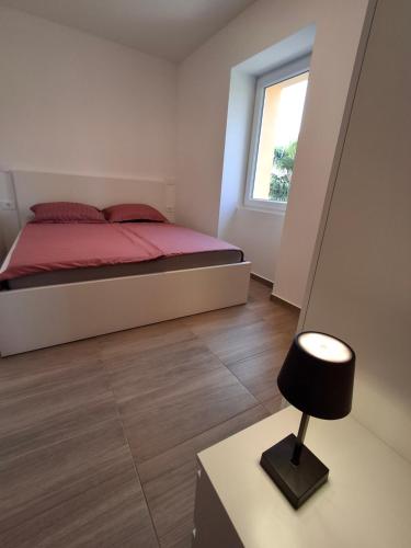 a bedroom with a bed and a table with a lamp at Villa Ivana in Koper