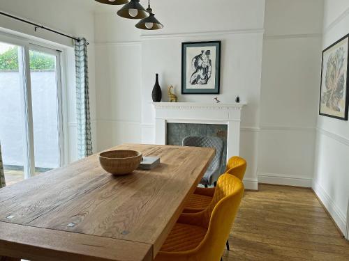 a dining room with a wooden table and chairs at Poppy Cottage in Eryholme