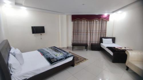 Ένα ή περισσότερα κρεβάτια σε δωμάτιο στο Summit Hotel Naran