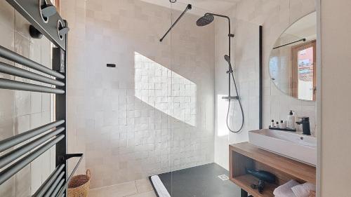 a white bathroom with a sink and a mirror at Intense Boutik-Hôtel in Port-Vendres