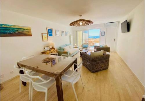 un salon avec une table et des chaises et une salle à manger dans l'établissement T3 vue imprenable sur la Crique, à Sète