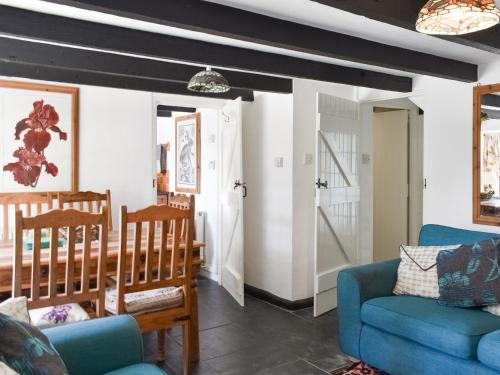 a living room with a blue couch and chairs at Barn Cottage - Uk47089 in Davidstow