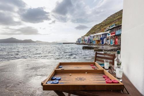 a wooden table sitting on the side of a body of water at Kalimera & Apoplous boathouse in Klima