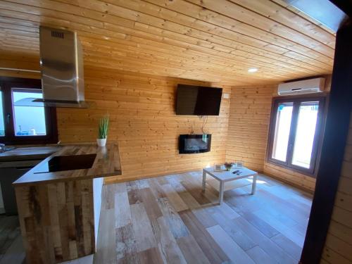 a living room with wooden walls and a table at Chalet Albariza in Sanlúcar de Barrameda