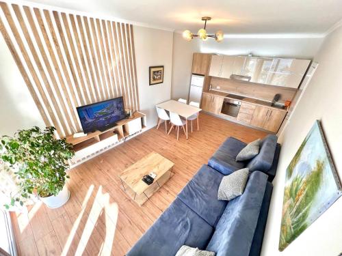 a living room with a blue couch and a table at Vista Adriatic Cz By Adriatic Living in Durrës