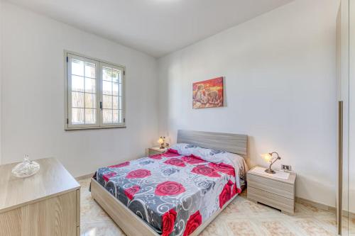 a bedroom with a bed and two night stands at Salentoandmore - Smeralda Onda Blu in Marina di Pescoluse