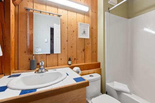 a bathroom with a sink and a toilet at Bear Coast, Cabin with Hot Tub, Patio, and Waterview in Ucluelet