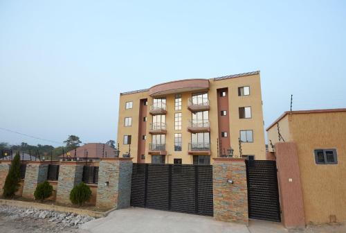 a building with a gate in front of it at Monroe Luxury Apartments in Kumasi