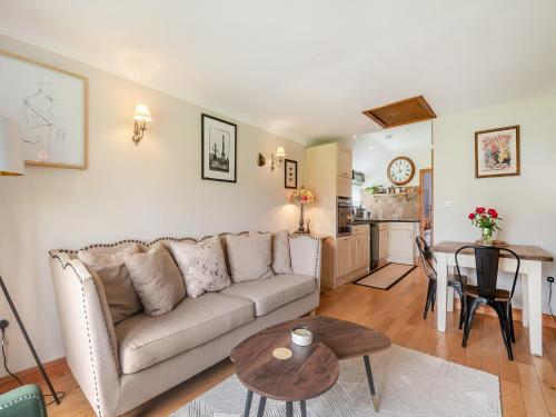 a living room with a couch and a table at Lidsey Farmhouse in Bognor Regis