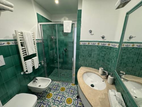 a bathroom with a sink and a toilet and a shower at Il Moro Di Positano in Positano