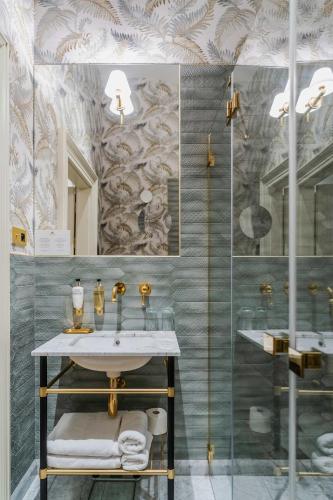 a bathroom with a sink and a shower at Hotel Unicus Palace Old Town - Destigo Hotels in Kraków