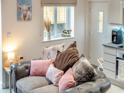 a living room with a couch with pillows on it at Oswald's Rest in Bamburgh
