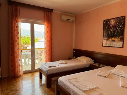 a hotel room with two beds and a balcony at ROOM 03 Villa KRIVOKAPIC in Budva