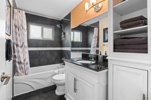 a bathroom with a white toilet and a sink at Luxury Retreat in Vancouver in Vancouver