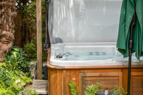 a bath tub sitting on top of a wooden stand at Luxury Retreat in Vancouver in Vancouver