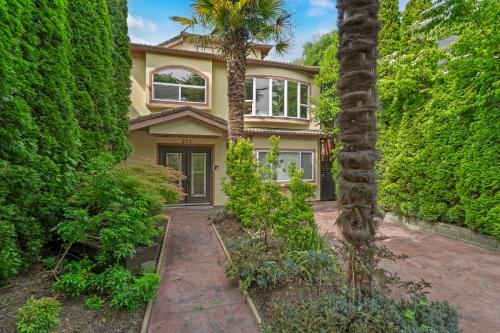 a house with a palm tree in front of it at Luxury Retreat in Vancouver in Vancouver
