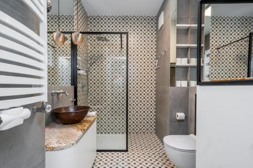 a bathroom with a sink and a toilet and a shower at Art Box - Gdańska Brzeźno in Gdańsk