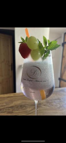a drink with grapes and fruit on top of a table at Vinný sklípek Drápalík in Milovice