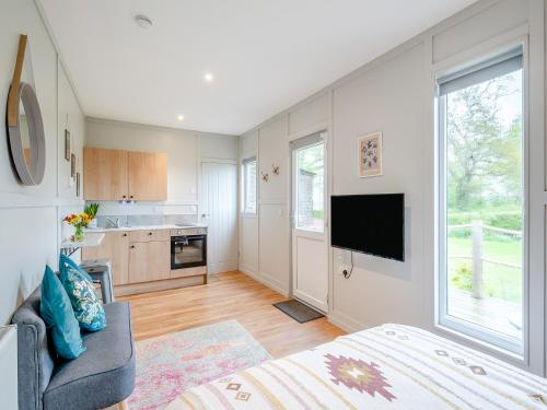 a living room with a bed and a tv and a kitchen at Willow Lodge 1 - Uk48642 in Taunton