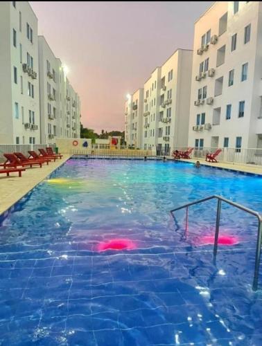 a large swimming pool in front of some buildings at Vacaciones Inolvidables in Coveñas