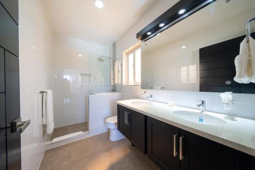 a bathroom with a sink and a shower and a toilet at Ocean View, Style, Freedom in Sosúa
