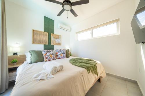 a bedroom with a large bed with a ceiling fan at Ocean View, Style, Freedom in Sosúa