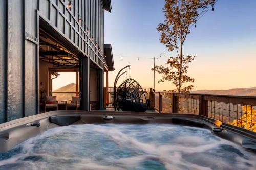a hot tub on the balcony of a house at 5 Suites - 180 View - Pool-Spa-Theater - Fireplace in Sevierville
