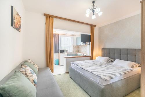 a bedroom with a bed and a couch at Apartments Katarine Zrinske in Vodice