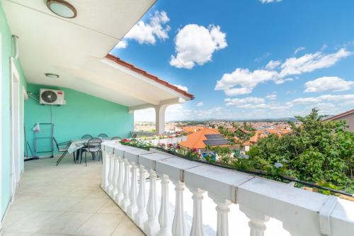 a balcony with a view of a city at Apartments Katarine Zrinske in Vodice
