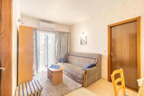 a living room with a couch and a table at Apartments Katarine Zrinske in Vodice