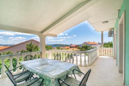 a patio with a table and chairs on a balcony at Apartments Katarine Zrinske in Vodice
