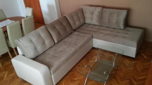 a brown couch in a living room with a table at Apartments Mira in Bibinje