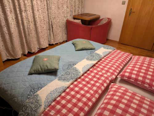 a bed with two pillows on it in a room at Montahaus Retro Apartments in Vandans