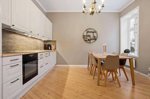 a kitchen with a table and a dining room at Stylish 1-bedroom Oslo apartment in Oslo