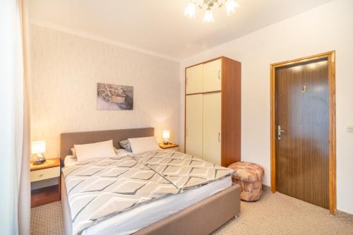a bedroom with a large bed and a closet at Apartments Katarine Zrinske in Vodice