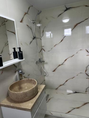 a bathroom with a stone sink on a counter at Dream House borjomi sadgeri in Sadgeri