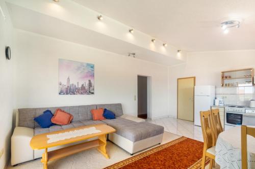 a living room with a couch and a table at Apartments Katarine Zrinske in Vodice