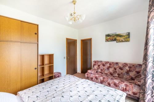 a bedroom with a bed and a couch at Apartments Katarine Zrinske in Vodice